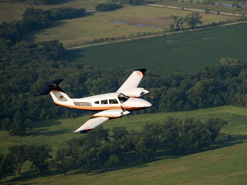 OSU plane flying above open field